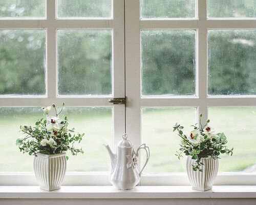 white-teapot-and-tow-flower-vases-on-windowpane