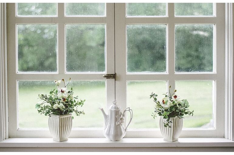 white-teapot-and-tow-flower-vases-on-windowpane